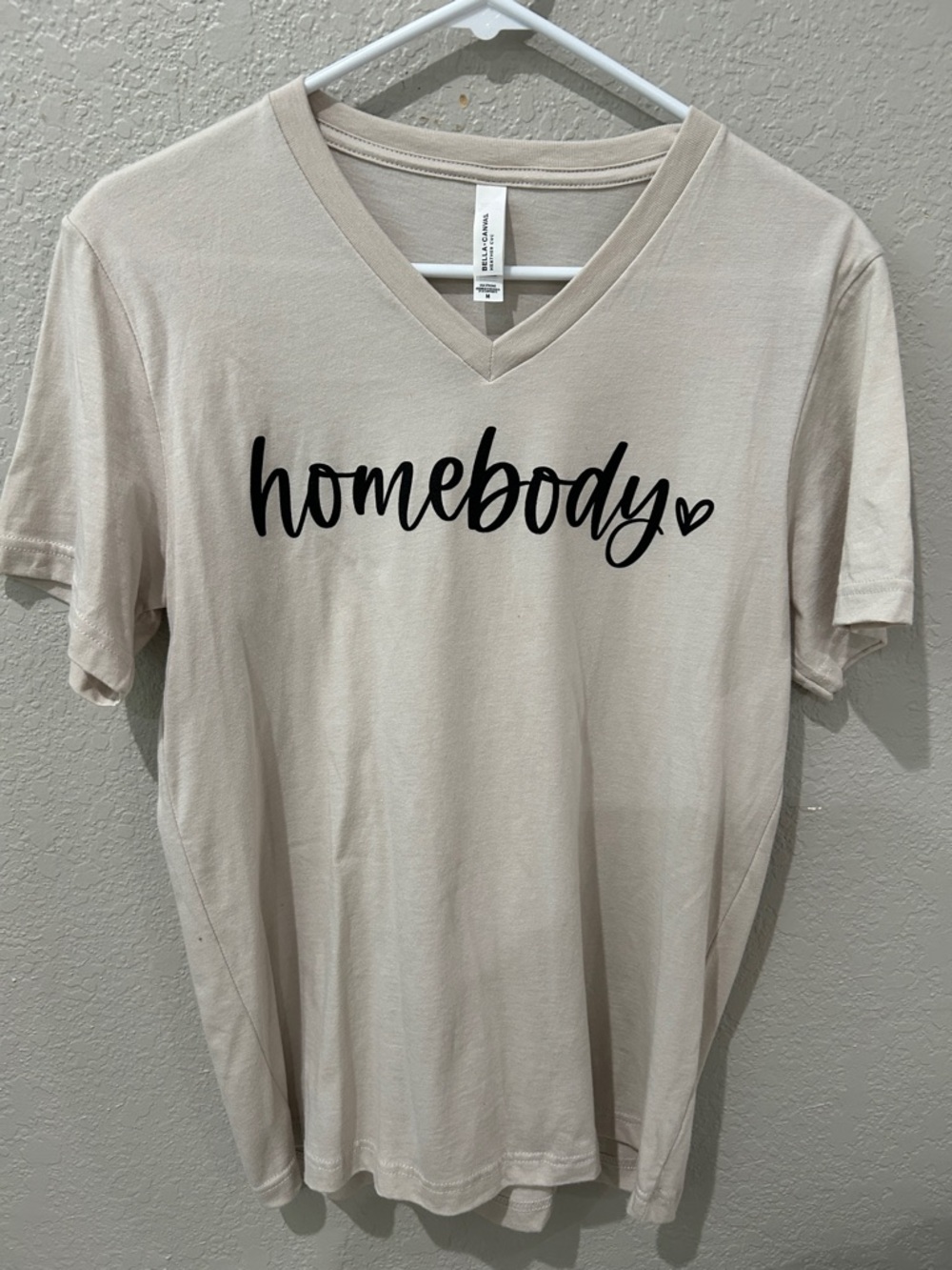 Bella Canvas "homebody" V‑Neck Tee in Light Beige with Black Script